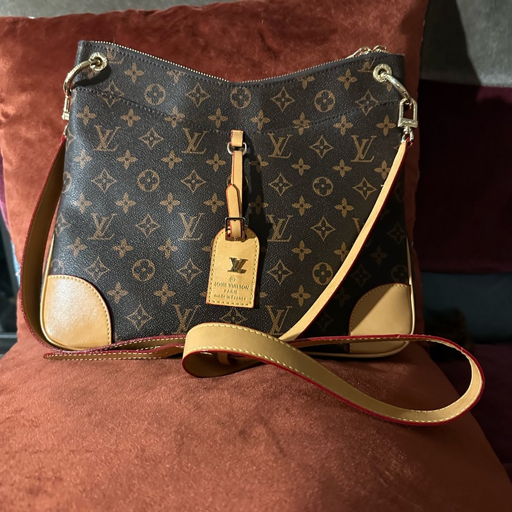 Louis Vuitton crossbody bag with adjustable straps and extra magnetic pocket